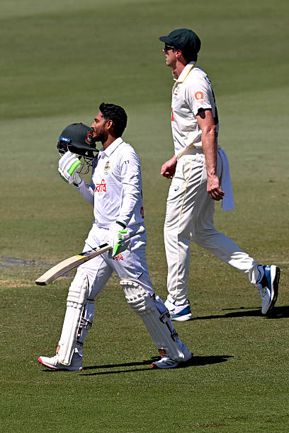 Tanzid kissing his helmet after century ©Getty