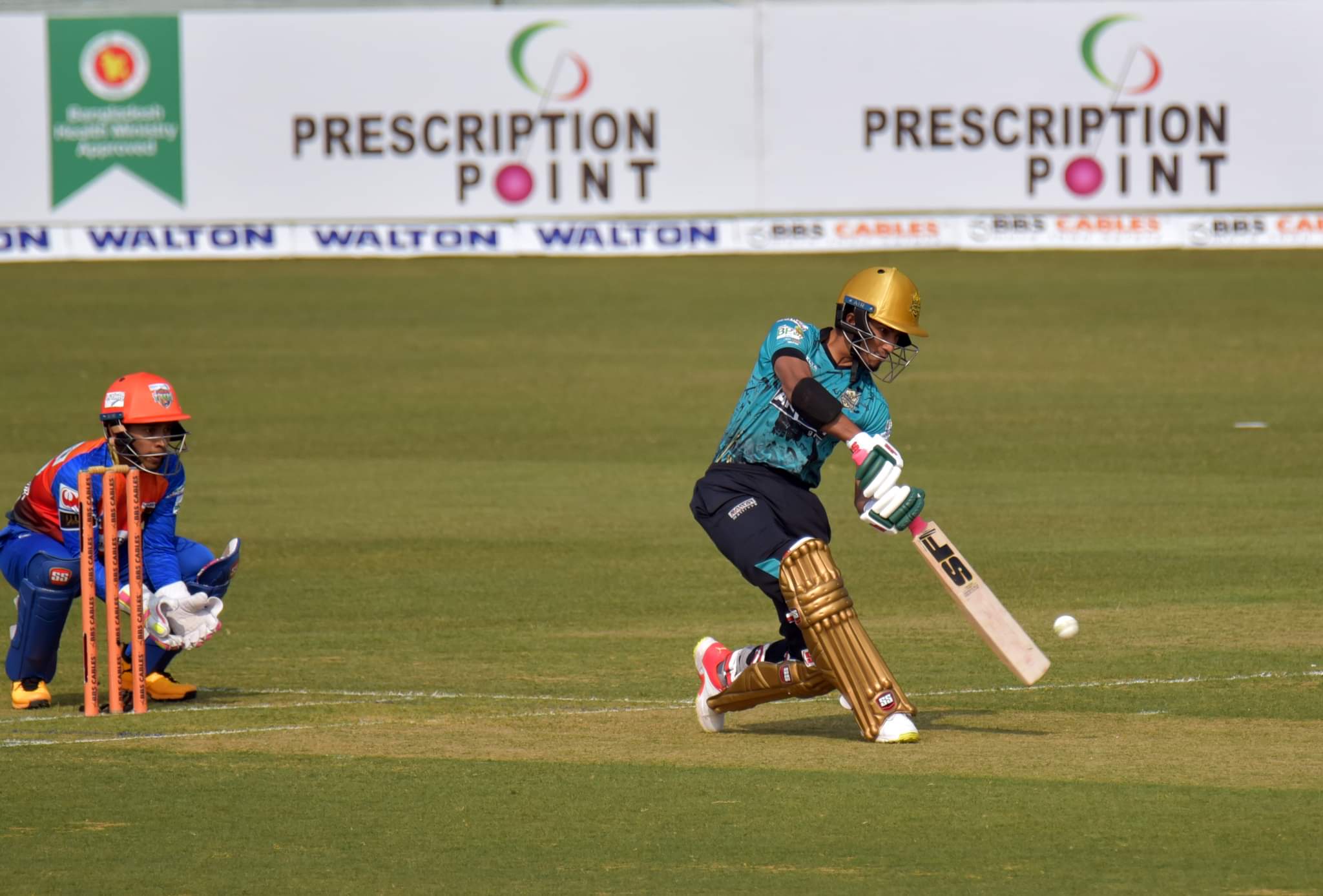 Afif Hossain dances down the wicket to hit out