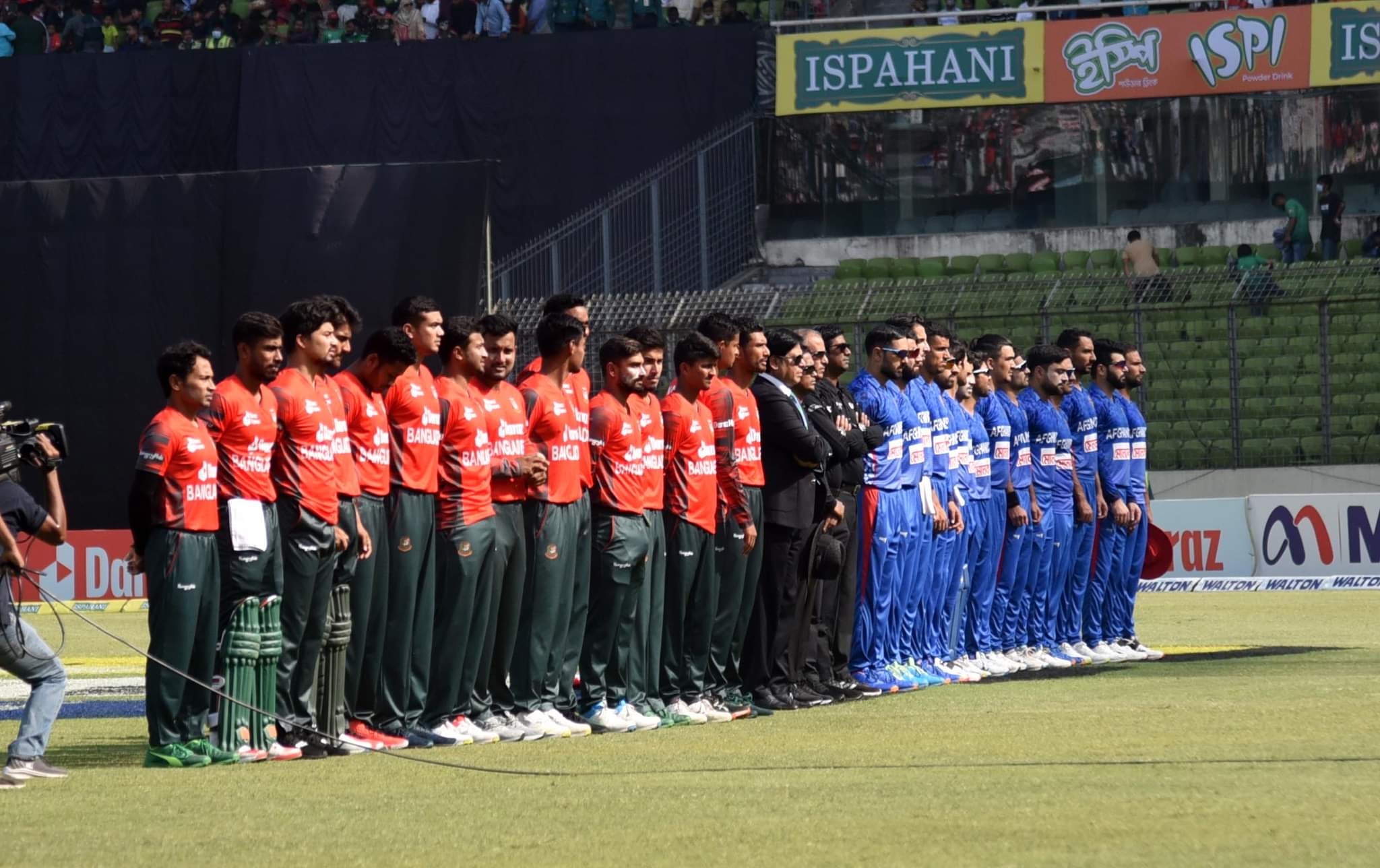 Bangladesh and Afghanistan players and match officials observe a minute of silence to remember late Rod Marsh and Shane Warne 